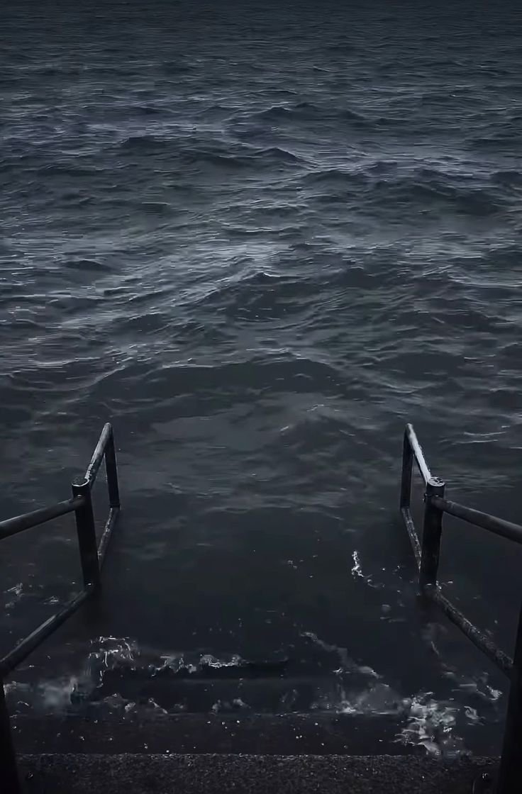 two steps leading to the ocean in the dark