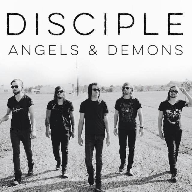 five men in black shirts and sunglasses walking across a dirt field with the words, disciple angels & demons