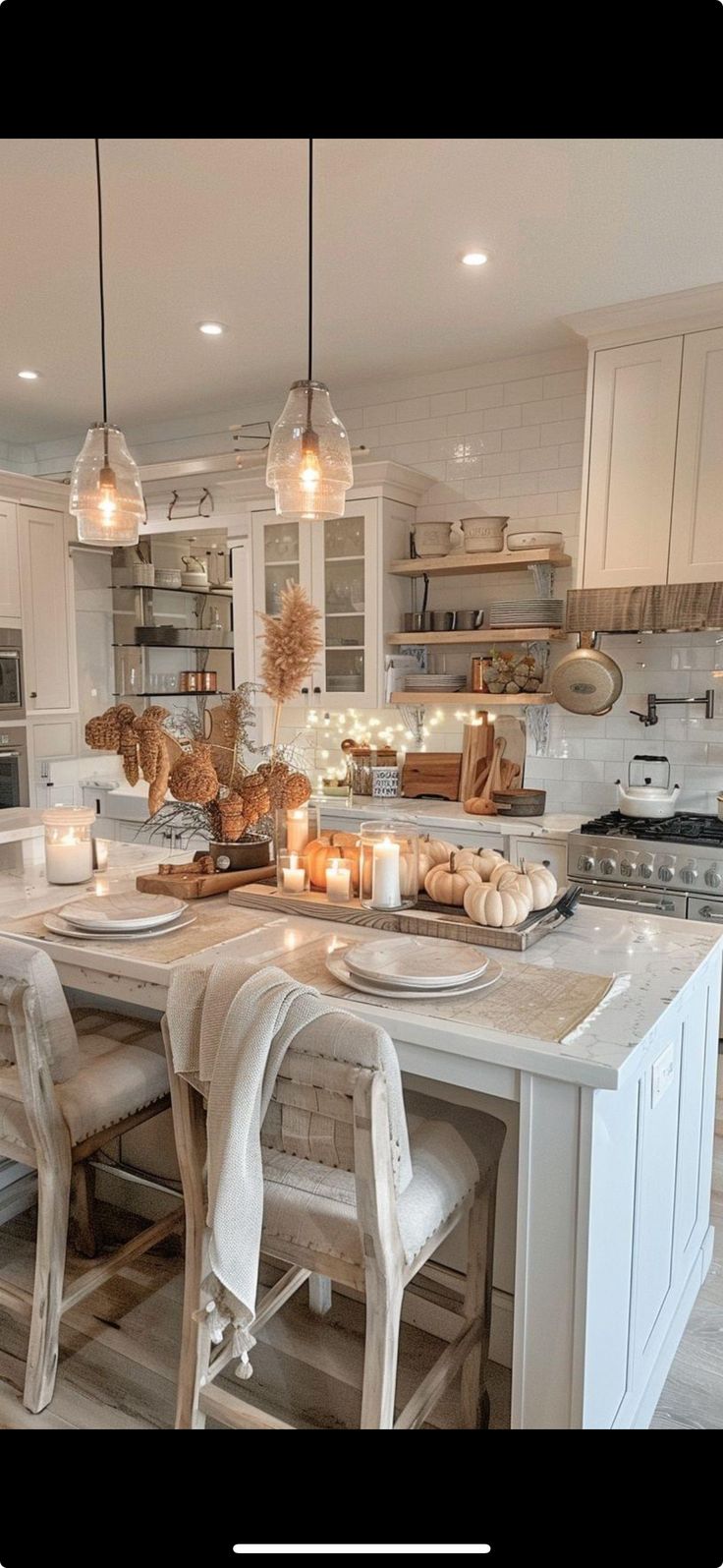 a kitchen filled with lots of white furniture