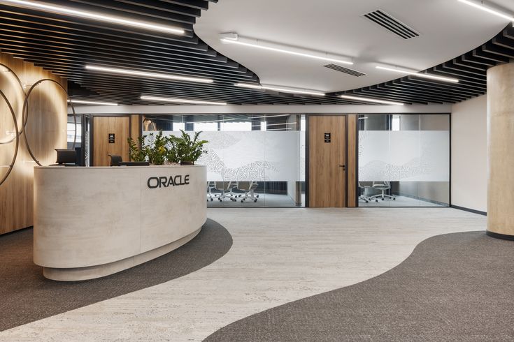 an office building with curved concrete walls and wood accents on the ceiling, along with large circular planters