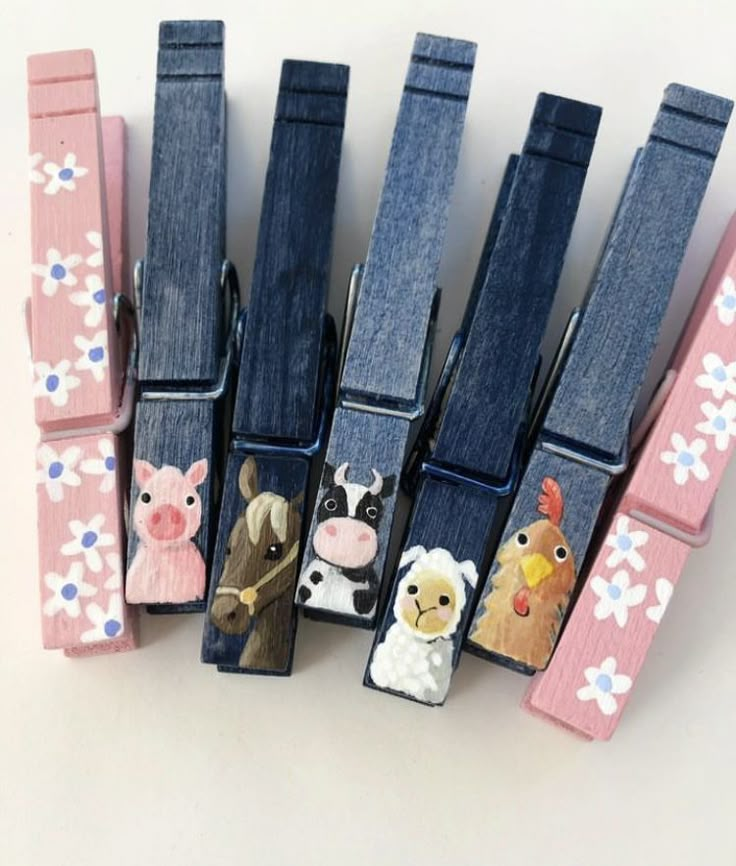 five pairs of dog and cat themed belt clips with flowers on them, all in different colors