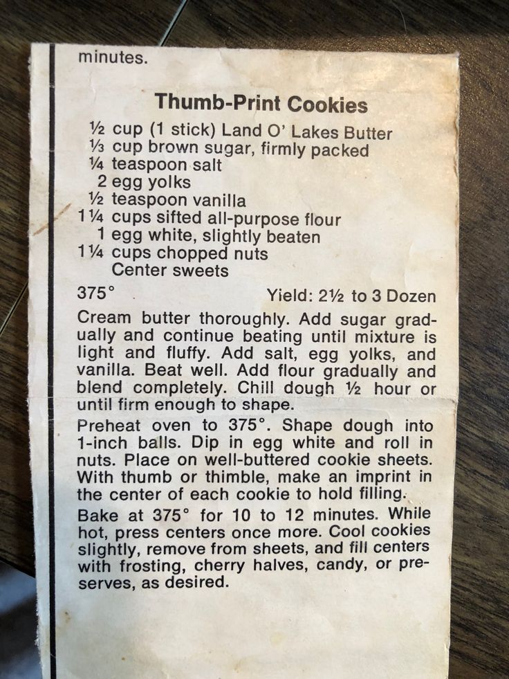 an old recipe for cookies on a wooden table