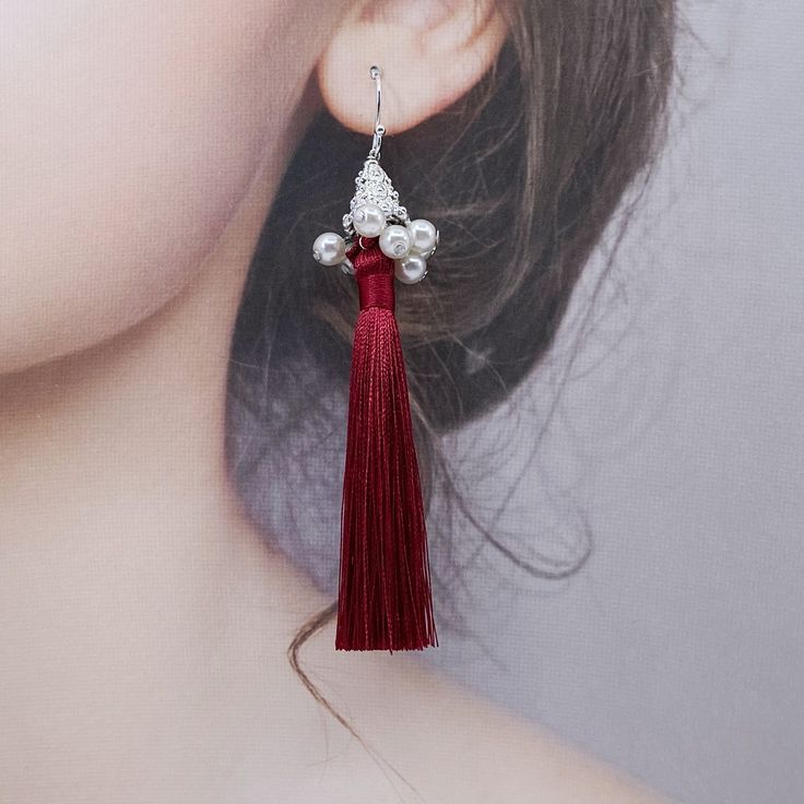 Elevate any outfit with these handmade tassel earrings. Made with premium silk tassels and faux pearl tassel caps, featuring a delicate filigree pattern. A perfect gift for New Year's or Christmas. Style them with a simple dress or blouse for an elegant look, pair with flowy top and denim for a bohemian vibe, or dress up a casual outfit with these statement earrings. Showcase the earrings fully by wearing your hair up, and perfect for special occasion like weddings or parties. ⚜Item Specifics ❀ Silk Tassels, Filigree Pattern, Asymmetrical Earrings, Christmas Style, Simple Dress, Flowy Top, Red Silk, Flowy Tops, Green Silk