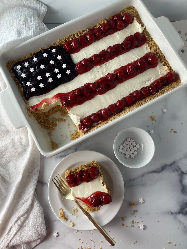 an american flag dessert in a baking dish with a fork and spoon on the side