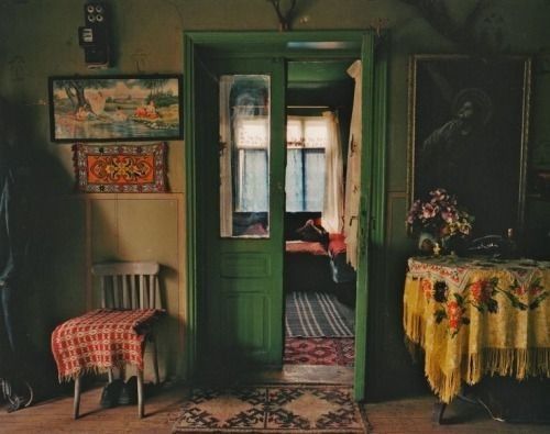 a room with green doors and pictures on the wall