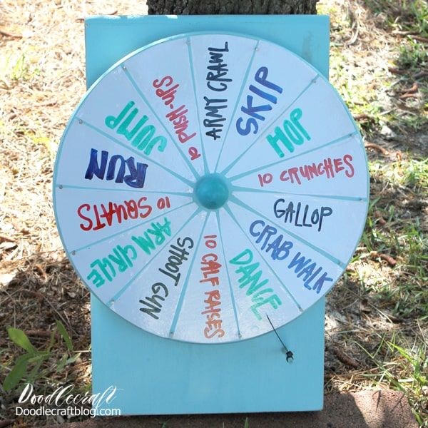 a wheel of fortune sitting next to a tree