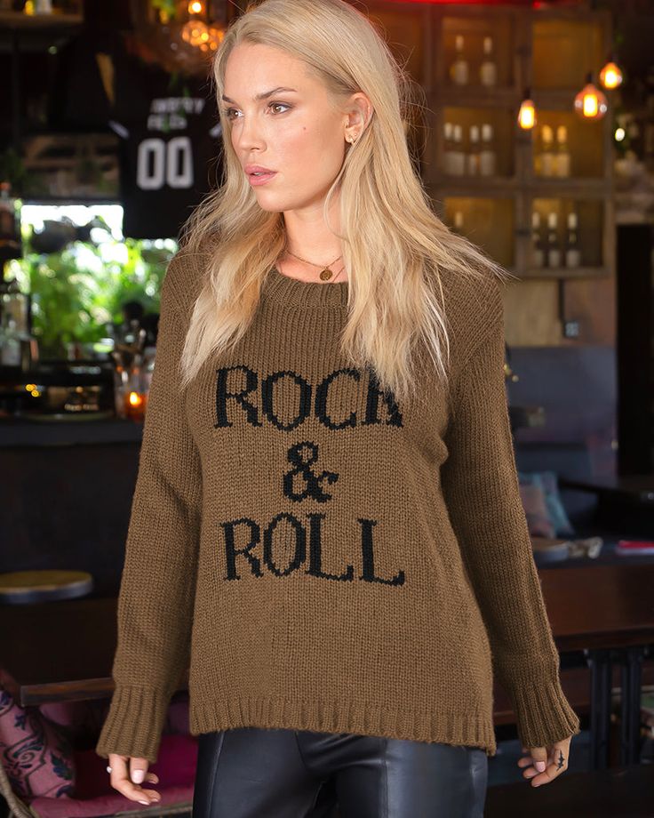 Buttery soft and incredibly cozy, this rocker chic top features the phrase "Rock & Roll" knit directly into the center front. The fit is relaxed and flattering and features mini side slits on each side. Cozy details include ribbing on the neckline, hem and cuff. Composition: 76% acrylic, 12% Mohair and 12% Wool Beach Sweater, Leopard Jeans, Wooden Ship, Graphic Sweaters, Rocker Chic, Soft Clothes, Cozy Cardigan, Oversized Knitted Sweaters, Oversize Knit