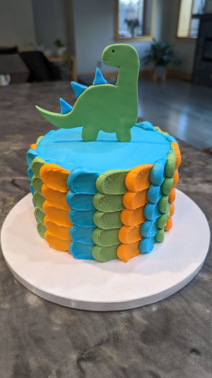 a birthday cake decorated to look like a dinosaur