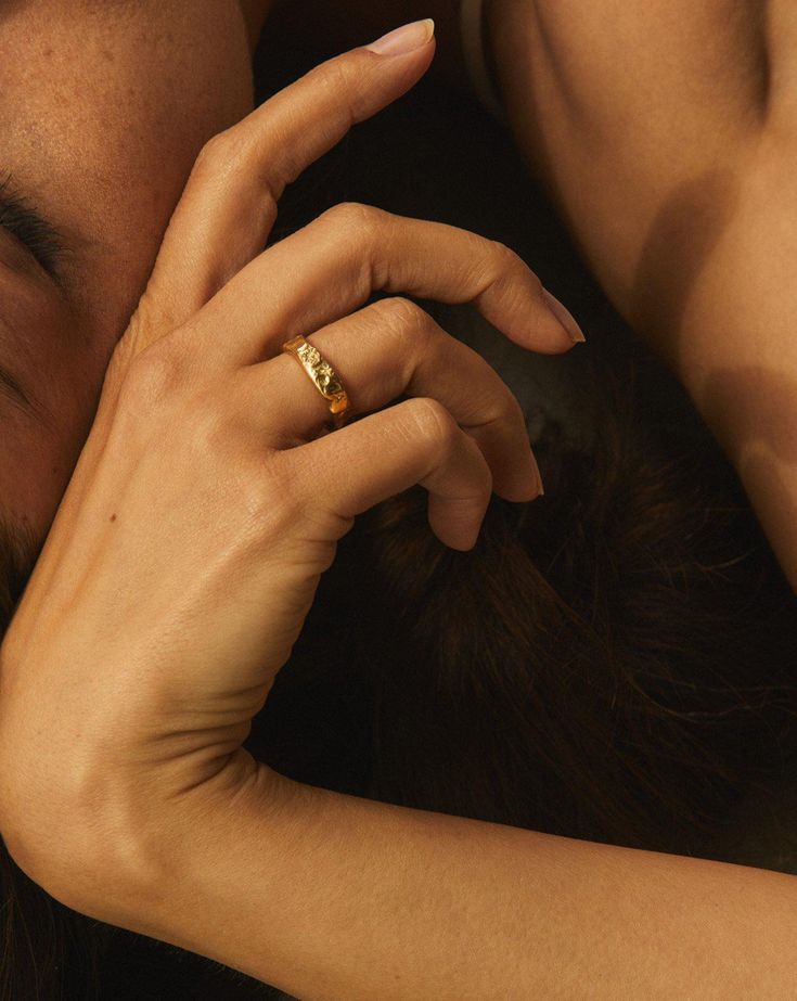 a close up of a person laying on the ground with their hand over her face