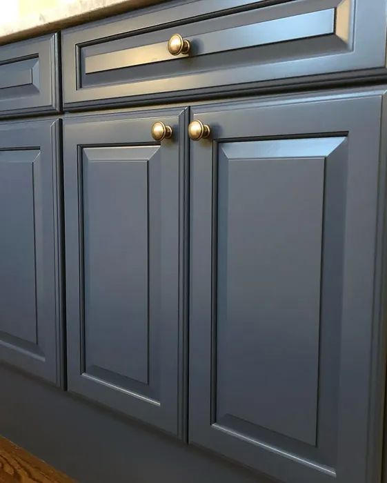 a kitchen with gray cabinets and gold knobs on the handles, drawers and cupboards