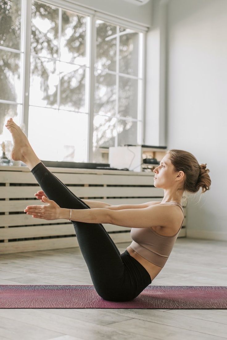 a woman is doing yoga on the floor