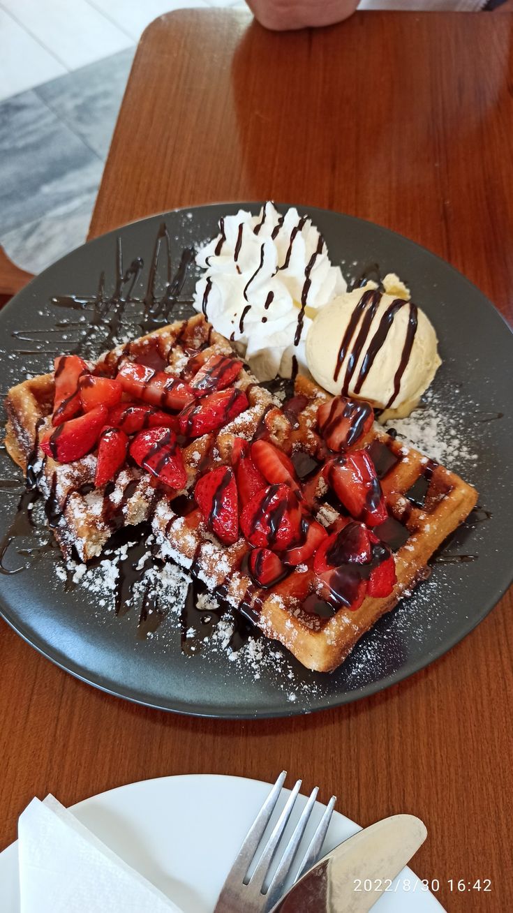 waffles, ice cream and strawberries on a plate