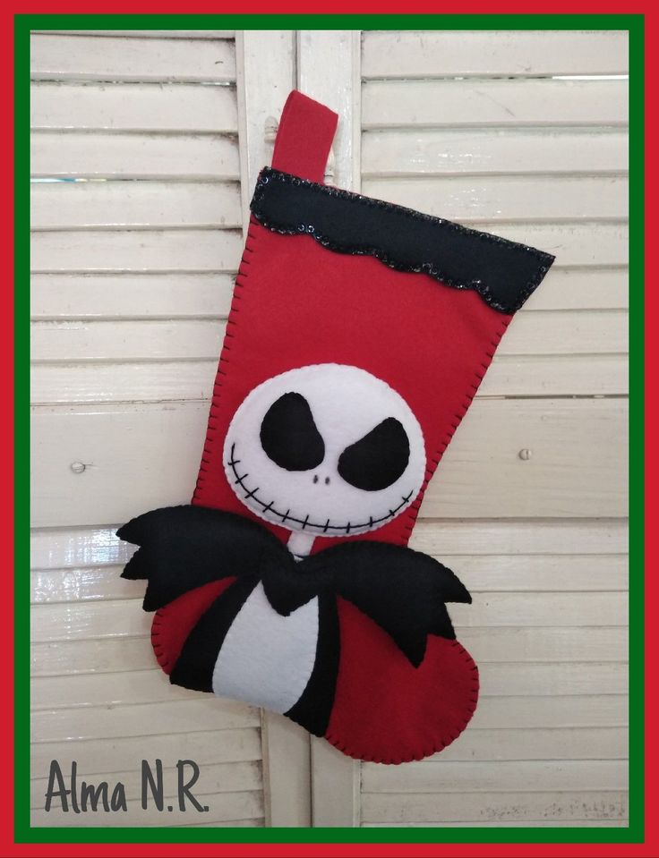 a christmas stocking hanging on the side of a door with a jack skellingy face