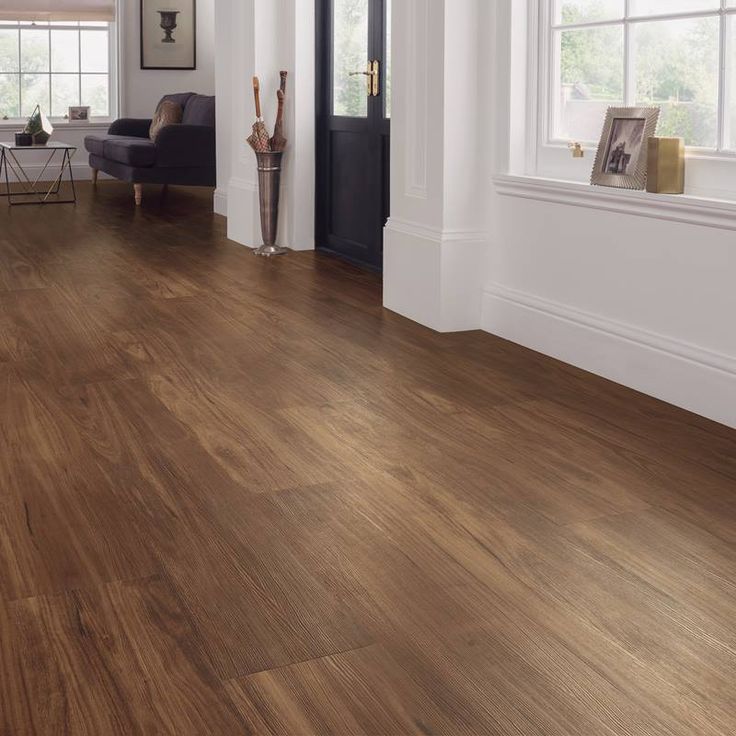 a living room with wood floors and white walls