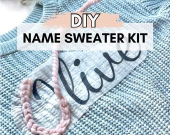 the name sweater kit is displayed on top of a blue knitted sweater with pink thread