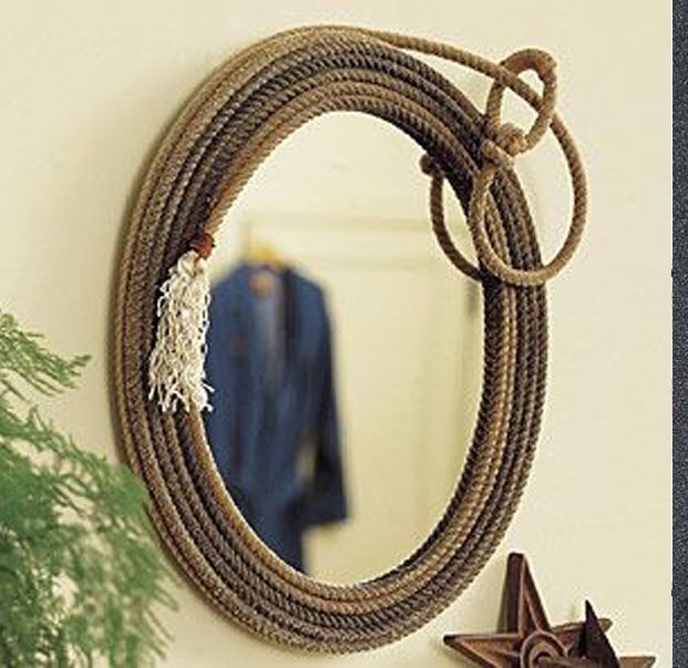 a rope hanging on the wall next to a potted plant and star shaped mirror