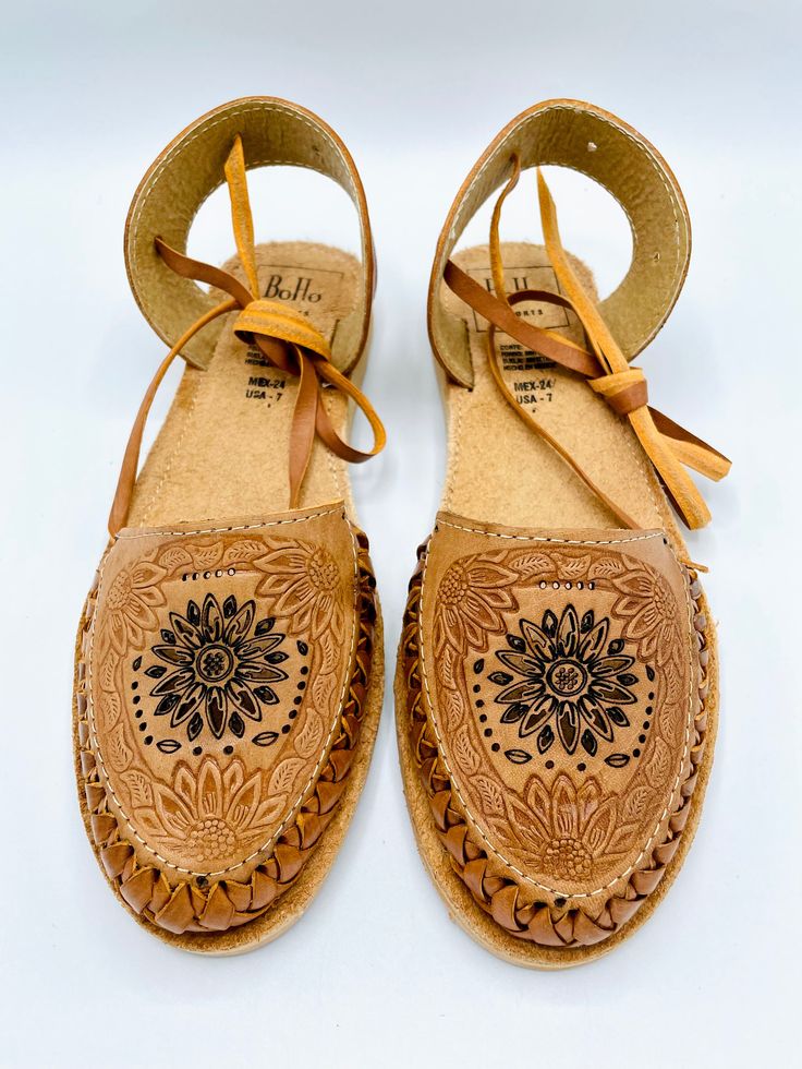 These stunners are unique and cute! The details in the flower design is stunning while the tie around straps are not easily found for most huaraches. Genuine Leather Light brown with flower design Handmade in Mexico Pro-tip! These fit true to size. If you are a half size and have a wider foot, size up. If you have a more narrow foot, size down. Adjustable Flower Sandals, Handmade Adjustable Huarache Sandals For Festival, Spring Adjustable Lace-up Huarache Sandals, Spring Lace-up Adjustable Huarache Sandals, Adjustable Lace-up Huarache Sandals, Adjustable Lace-up Huarache Sandals For Spring, Adjustable Lace-up Huarache Sandals For Summer, Spring Festival Adjustable Huarache Sandals, Adjustable Lace-up Huarache Sandals For Beach