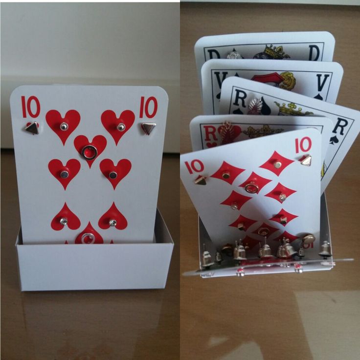 four playing cards in a box on a table with the numbers ten, ten and ten