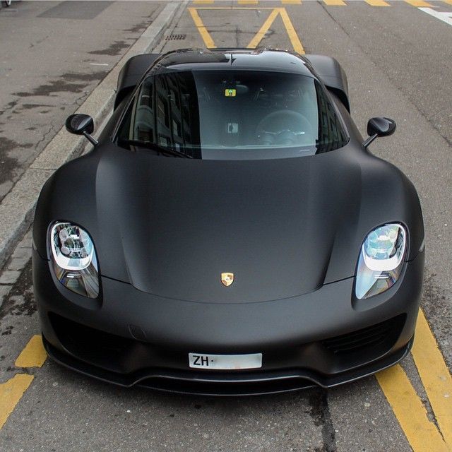 a black sports car is parked on the street