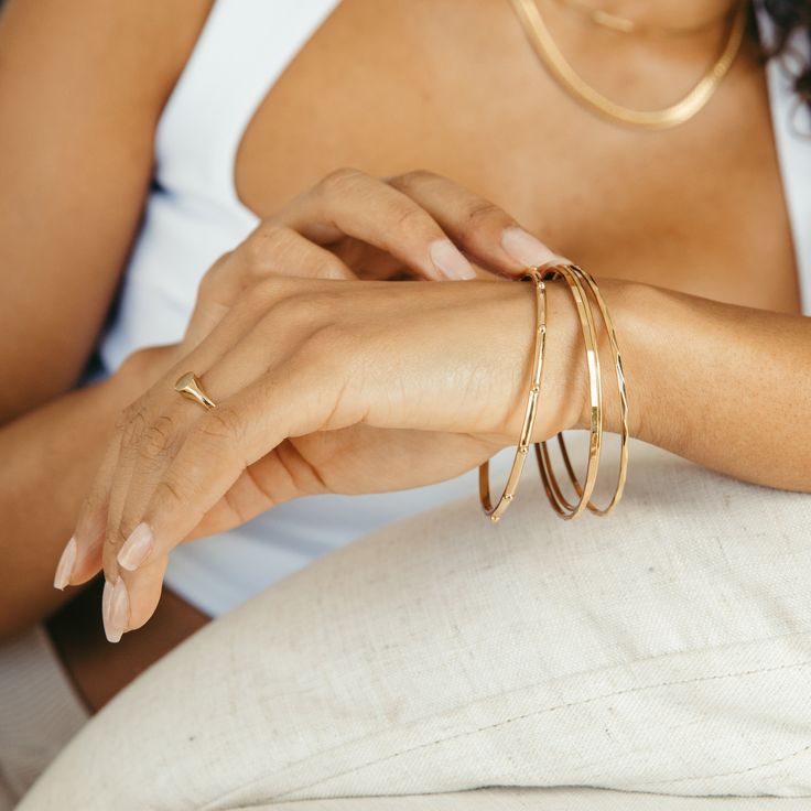 The Demi Bangle Bracelet is a chic, minimalistic accessory that adds a subtle yet sophisticated touch of glamour to your look. Crafted in a lightweight gold bangle, it'll elevate any ensemble with effortless elegance. So why not give your look an iconic finish? Get your must-have accessory now. Available in 14k gold plated brass Width: 2mm Interior diameter measures 2 1/2" SKU: BYB1180 Pattern Bracelet, Modern Jewellery Design, Minimalist Accessories, Simple Look, Gold Bangle Bracelet, Gold Bangle, Effortless Elegance, Beautiful Packaging, Gold Bangles