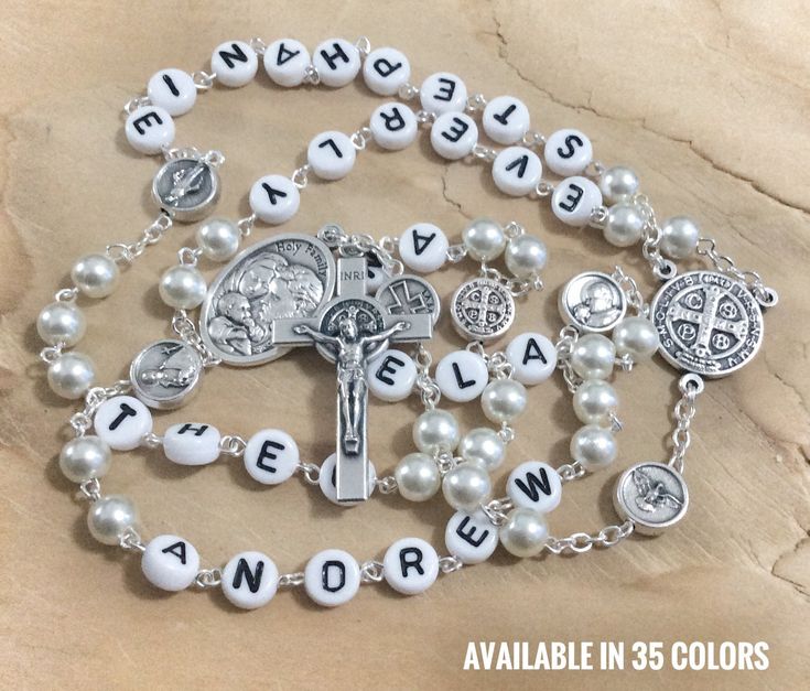 "This rosary is full customizable with your family names (up to 10 letters per decade and your choice of 6mm glass beads. The centrepiece is St Benedict medal. It is ending with St Benedict cross with attached medal of Holy Family. On the place of Our Father beads are silver tone saint medals: St Gerard,St Anthony/St John Paul II,St Benedict, Miraculous medal,Holy spirit and Holy face. You can select up to 5 names (10 characters or less per name) And put the names you would like at \"note to sel Customizable White Jewelry For Memorials, Customizable White Jewelry For Memorial, Customizable White Memorial Jewelry, Personalized Spiritual Rosary Gift, Personalized White Rosary, Personalized Adjustable Rosary With Round Beads, Personalized Rosary For First Communion, White Spiritual Jewelry With Custom Name, Custom Name White Spiritual Jewelry