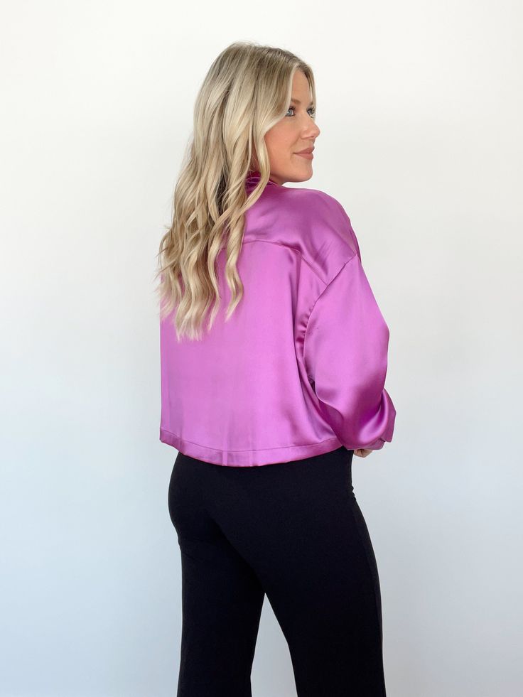 This Business Savvy Top is nothing short of luxurious! Crafted from soft and supple satin, wearing this top will ensure you look elegant and tasteful, with a touch of sophistication. The classic collared neckline, elevated with a pop of color, is accentuated with subtle button closures for a look that is both stylish and timeless. Relaxed and comfortable, this top is perfect for the office, for school, or for any event that requires a touch of class. 100% Polyester Hand wash cold separately. Satin V-neck Blouse For Night Out, Feminine Satin Tops For Workwear, Feminine Satin Tops For Work, Chic Solid Color Blouse With Collared Neckline, Chic Solid Blouse With Collared Neckline, Chic Satin V-neck Tops, Sleek Solid Blouse For Night Out, Sleek Collared Satin Tops, Sleek Satin Collared Tops