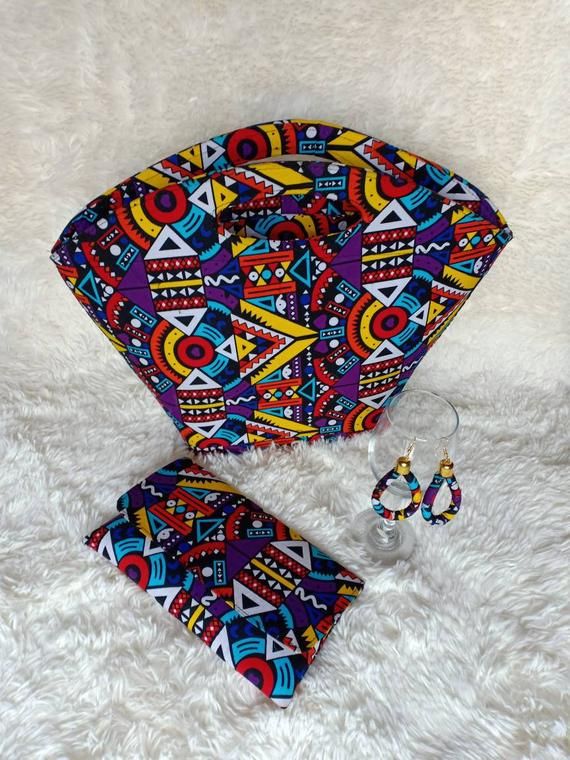 ***African tribal bag, 100% handcrafted using tribal fabric material .***fully lined,***it has a zip and extension zipper inside***It's a perfect gift for her. ***Can also be used as a office bag. **It has a matching purse and earrings.**It's 8 by 12***It is 8"length ×12inches***Perfect christmas gift for her***For wholesale kindly message us.Ship via dhl express. Multicolor Fabric Bags For Vacation, Multicolor Fabric Vacation Bags, Unique Multicolor Bags For Gifts, Bohemian Fabric Tote Bag, Colorful Handmade Bags For Gifts, Trendy Handmade Shoulder Bag For Festivals, Colorful Shoulder Bag For Gift, Bohemian Fabric Bag With Rectangular Shape, Bohemian Fabric Bags With Rectangular Shape