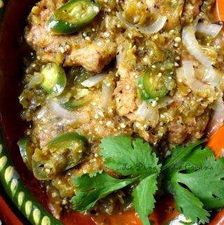 an orange bowl filled with meat and vegetables