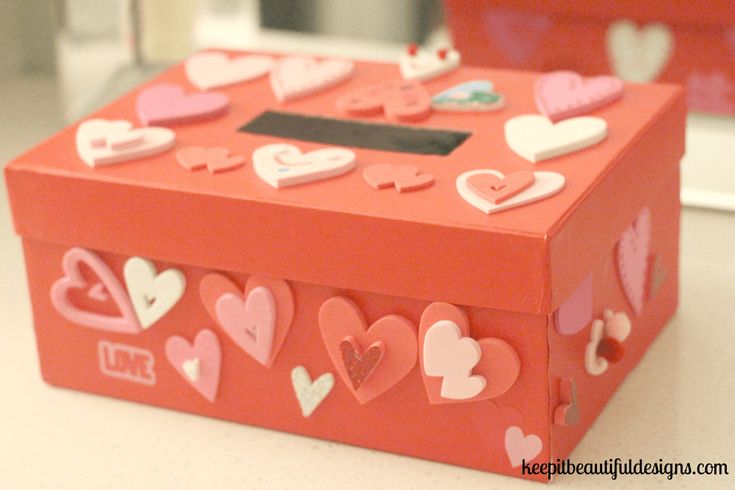 a red box with hearts on it sitting on a table