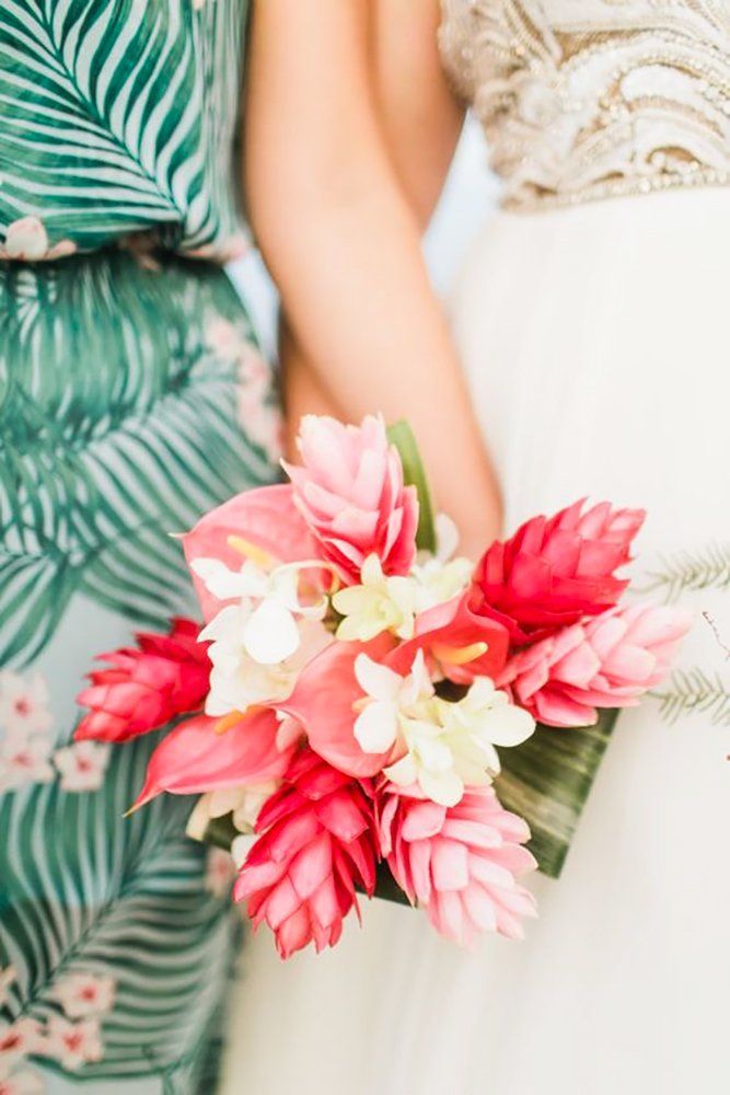 two bridesmaids holding bouquets with pink and white flowers in their hands, close up