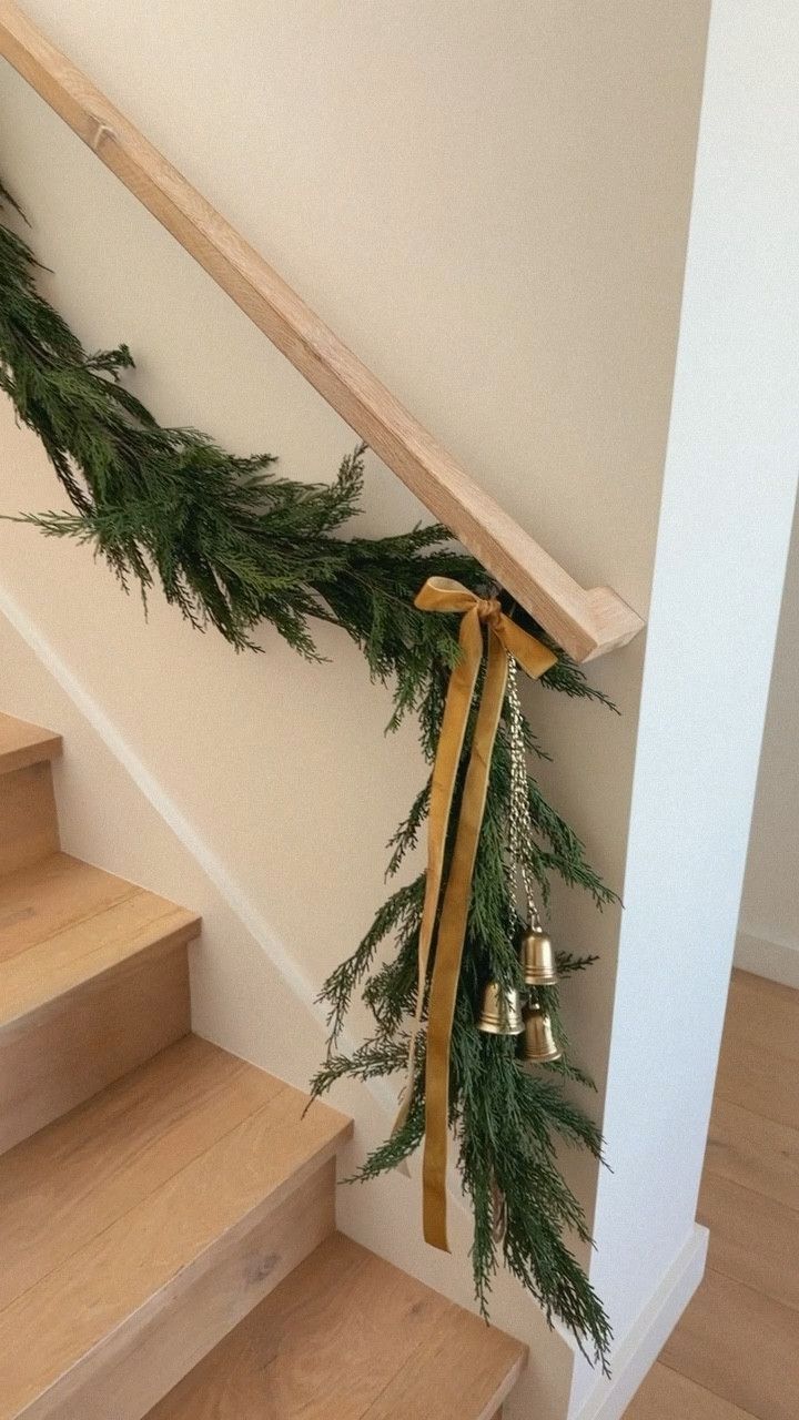 the garland is tied to the banisters on the stairs