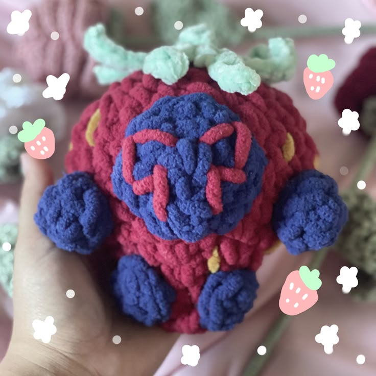 a hand holding a crocheted stuffed animal