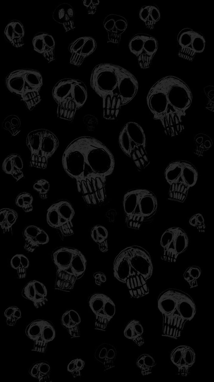 a bunch of skulls on a black background