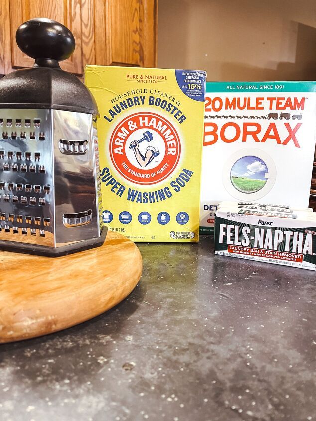 an old grater sits on top of a counter next to books and other items