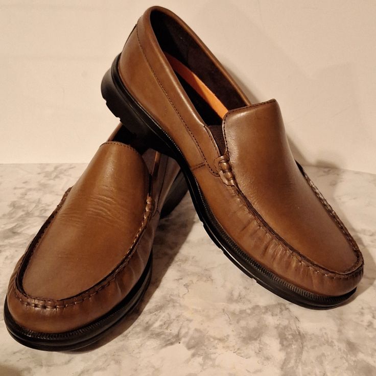 Rockport Palmer Venetian Leather Loafers. Cognac Antique Color. The Palmer Is A Luxe Collection Of Modern Loafers Engineered For All-Day Comfort. These Hand Sewn Fabric Classics Construction Offers A Glove-Like Fit And A Durable Outsole For A Smooth, Comfortable Ride. Pairs Well With Jeans, A Jacket At The Office, Or Out With Friends In Shorts And A Polo. Brown Casual Moc Toe Dress Shoes, Casual Wingtip Slip-ons With Leather Footbed, Formal Walking Shoes With Ortholite Insole And Round Toe, Brown Moccasins With Ortholite Insole For Formal Occasions, Classic Formal Walking Shoes With Ortholite Insole, Casual Slip-on Leather Shoes With Ortholite Insole, Classic Formal Walking Shoes With Round Toe, Casual Slip-on Dress Shoes With Moc Toe, Casual Moc Toe Dress Shoes With Leather Footbed