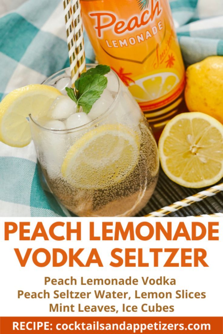 a bottle of peach lemonade vodka next to sliced lemons