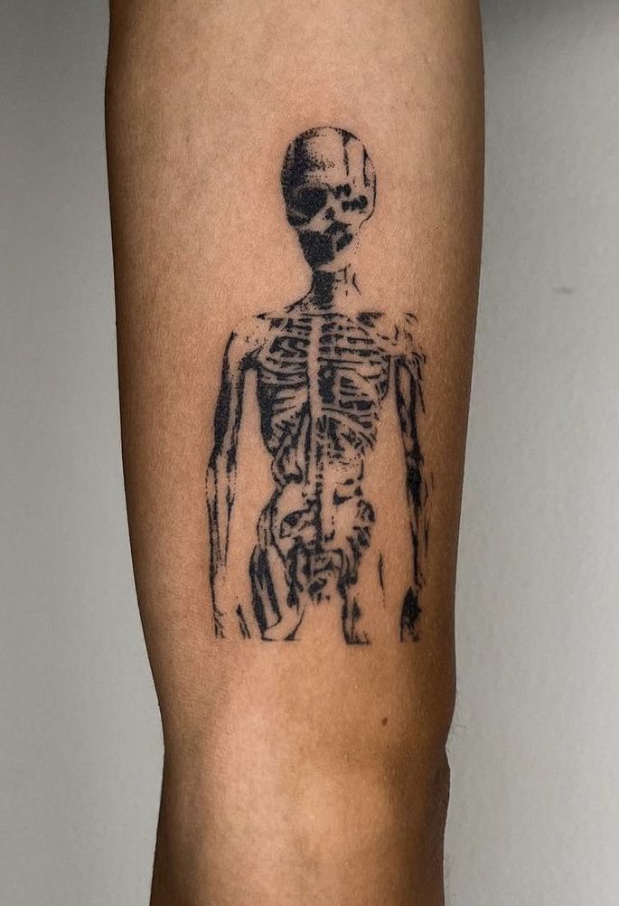 a person with a skeleton tattoo on their leg