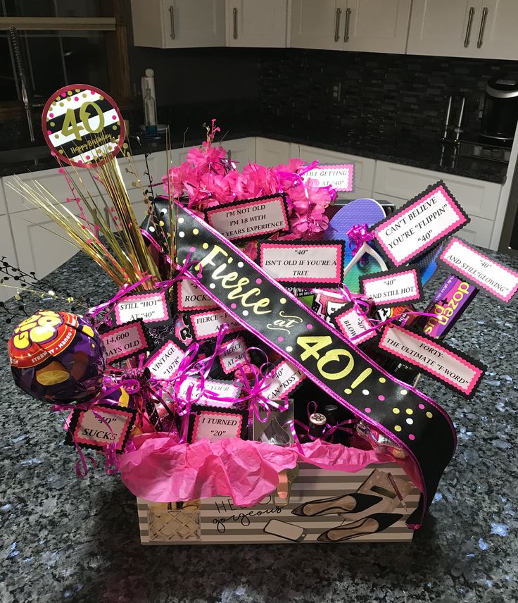 a birthday gift basket with lots of candy and decorations on the table in a kitchen