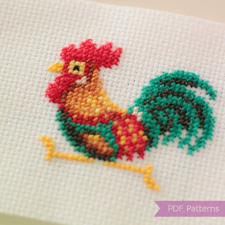 a cross stitch picture of a rooster