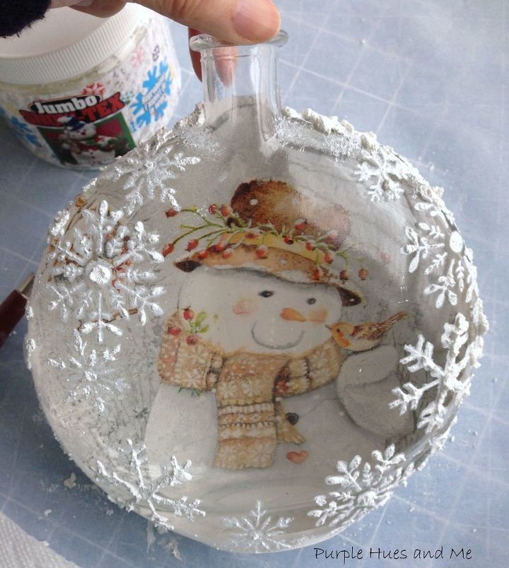 someone is making a snowman ornament out of paper