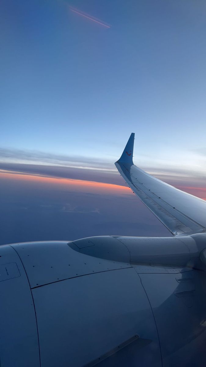 the wing of an airplane as it flies through the sky