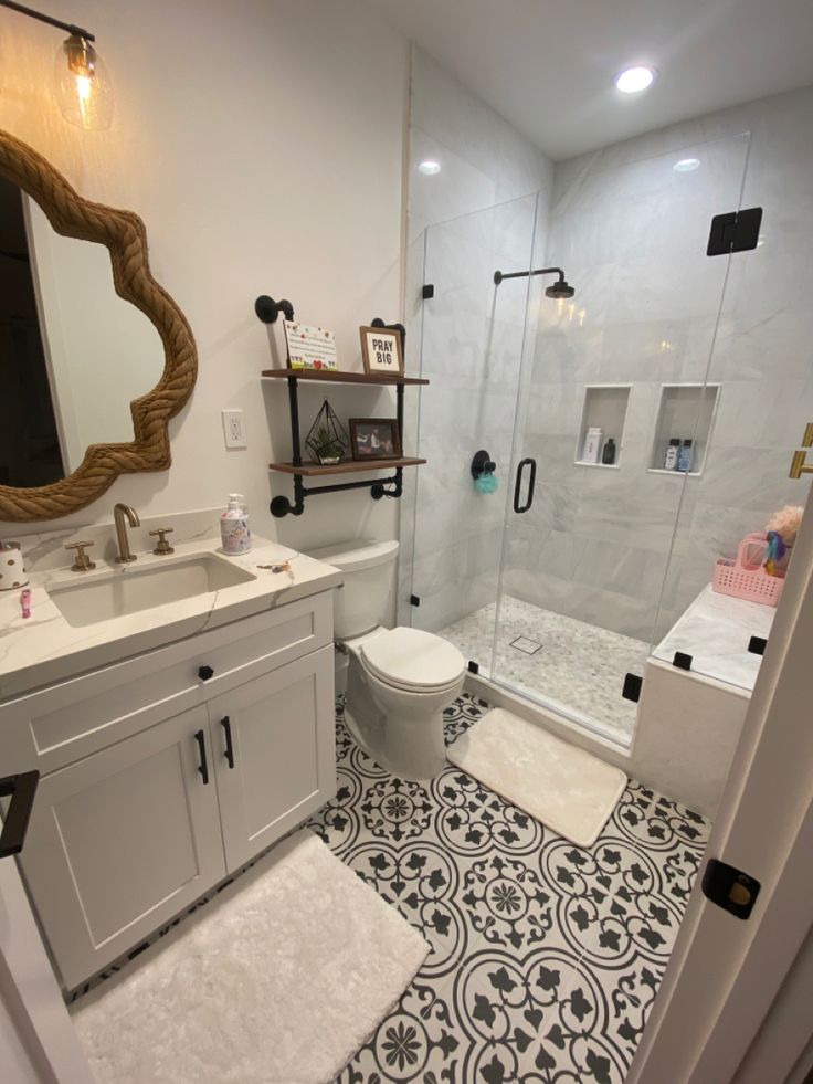 a bathroom with a sink, toilet and shower stall in it's center area