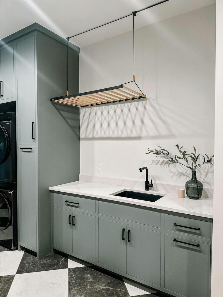 a washer and dryer in a room with black and white checkered flooring