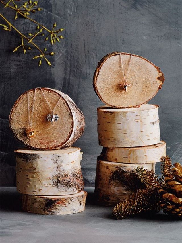 several pieces of wood stacked on top of each other with pine cones in the background