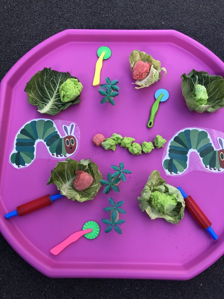 a purple plate topped with lettuce cutouts and stickers on top of it