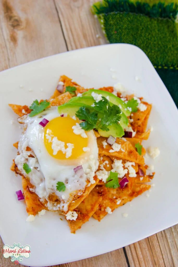 a white plate topped with food on top of a wooden table