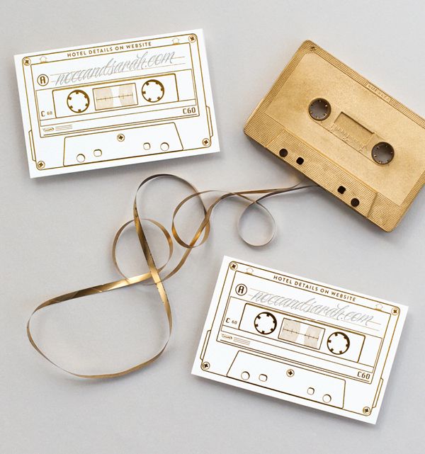 some tape and scissors are laying next to an old fashioned audio cassette with gold trim