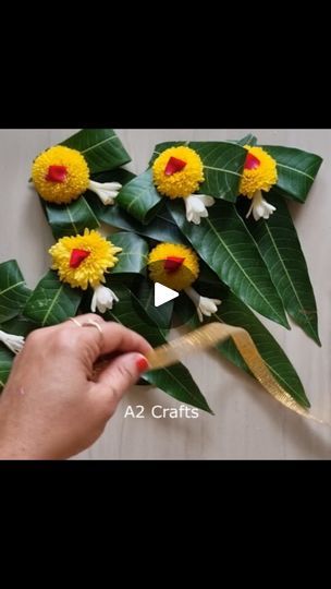 someone is making fake flowers out of leaves