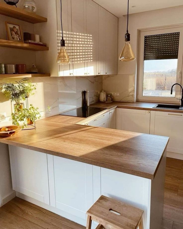 a kitchen with an island and wooden stools next to the counter top in front of a window