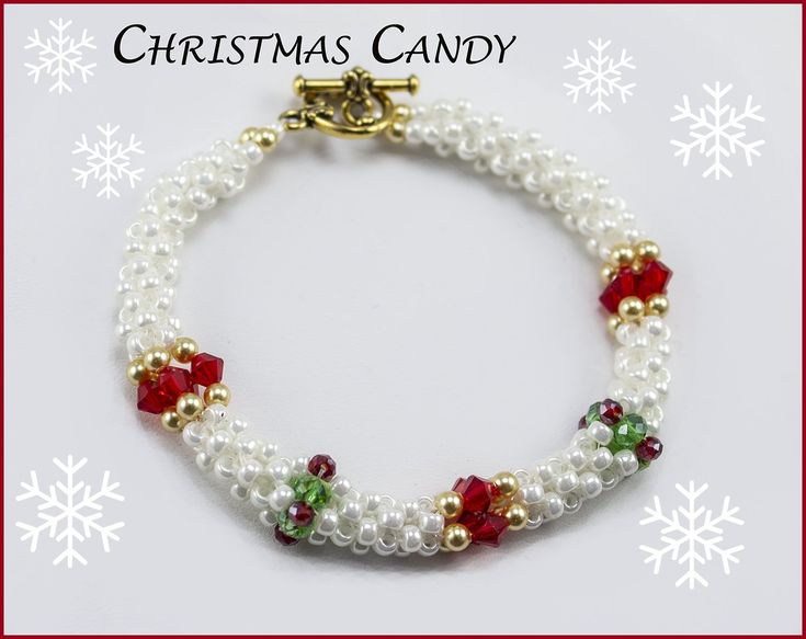 a white bracelet with red, green and gold beads is shown in front of snowflakes